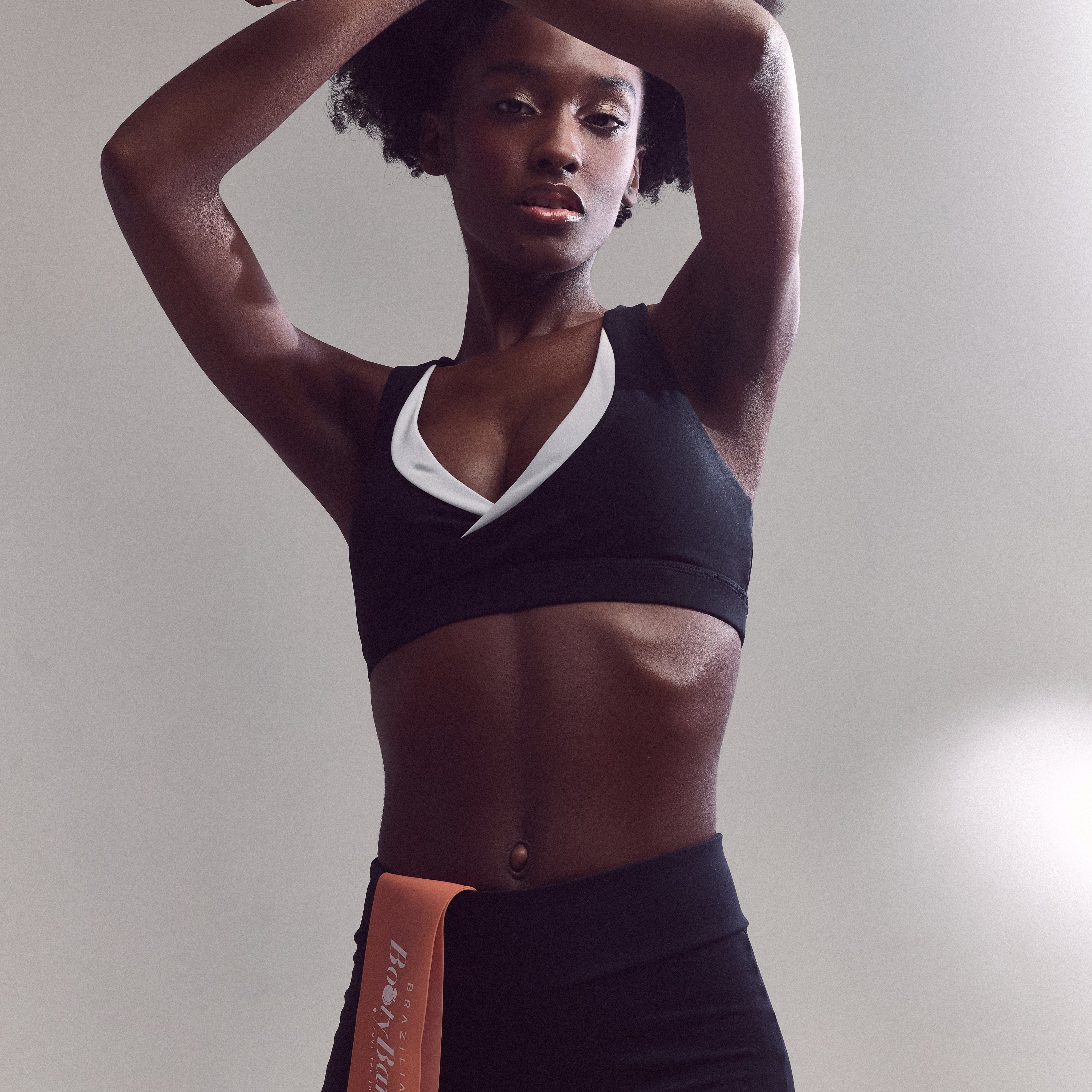 Strong female fitness model in Brazilian Booty Co gym outfit.