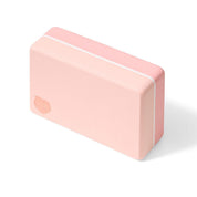 Pink yoga block with rounded edges and white stripes